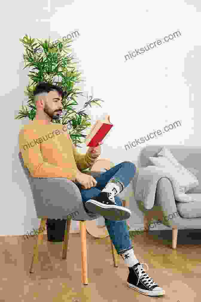 A Man Is Sitting In A Chair, Reading A Book. He Is Wearing A White Shirt And Glasses, And He Has A Smile On His Face. The Teacher Who Couldn T Read: One Man S Triumph Over Illiteracy