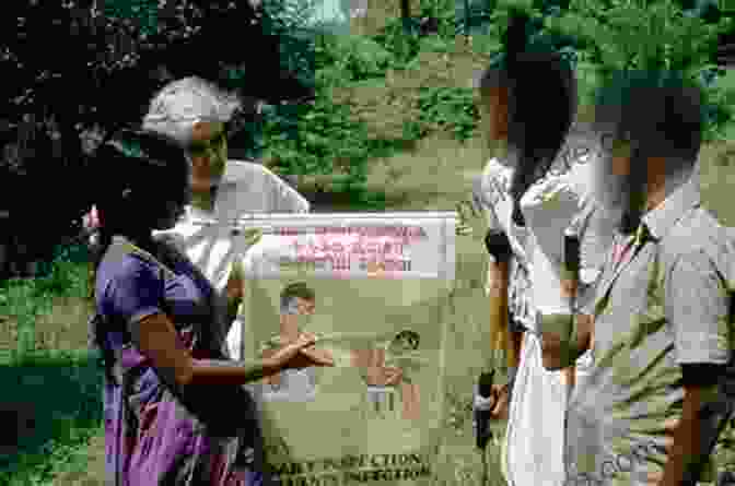 Photo Of A Leprosy Education Program, With A Healthcare Worker Teaching A Group Of People About The Disease Carville S Cure: Leprosy Stigma And The Fight For Justice